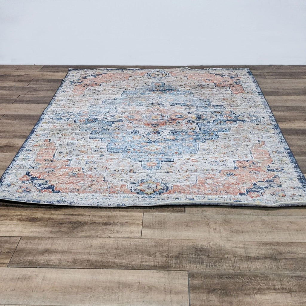NuLoom Celeste rug with vintage stonewashed finish and fringe, laid on wooden floor.