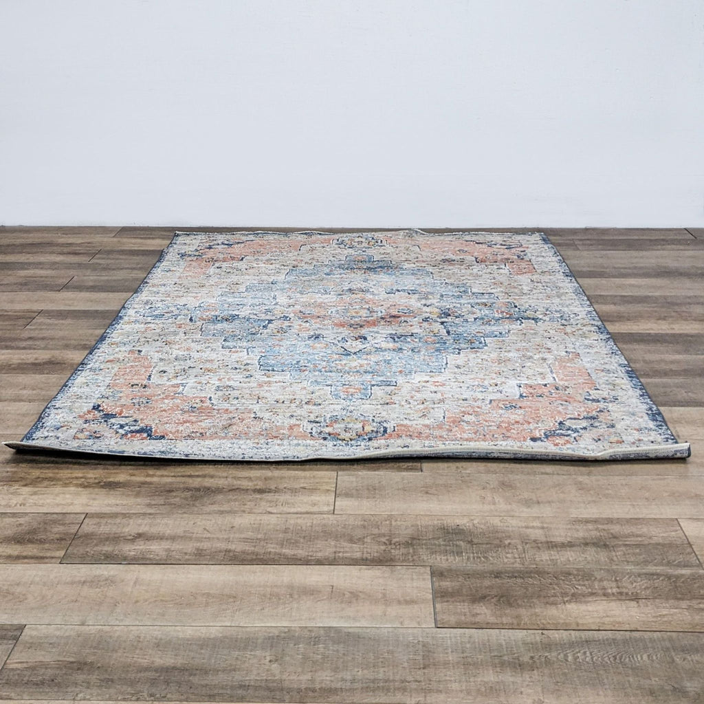 Vintage-style NuLoom area rug with intricate design, displayed on wood flooring.