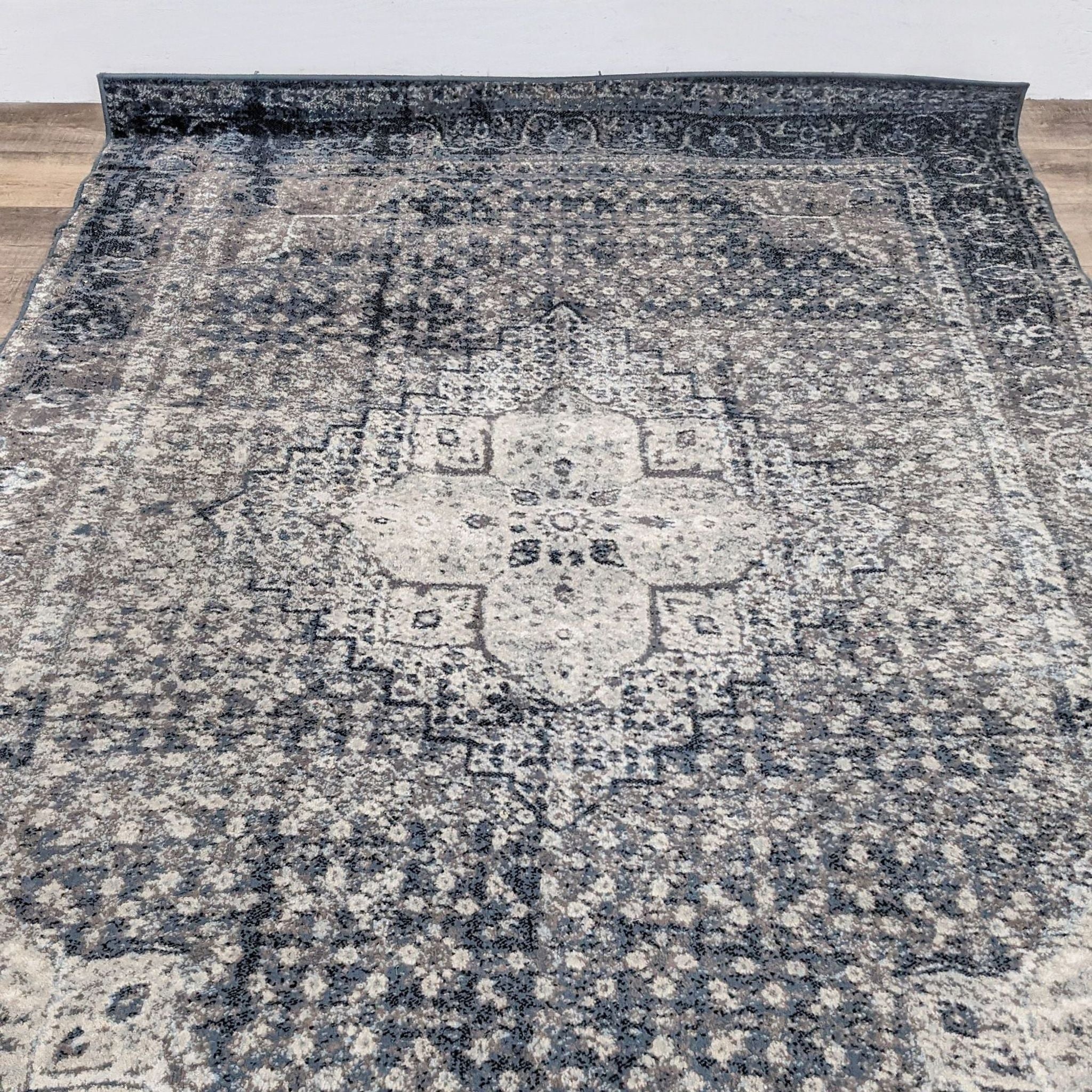 Close-up of the nuLOOM Kellum rug's intricate medallion and geometric patterns.