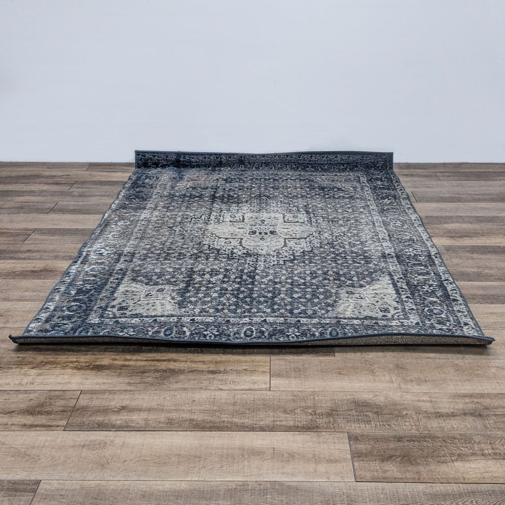 The nuLOOM Kellum rug, featuring a vintage medallion design, is laid on a wooden floor.