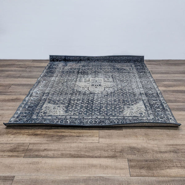 The nuLOOM Kellum rug, featuring a vintage medallion design, is laid on a wooden floor.