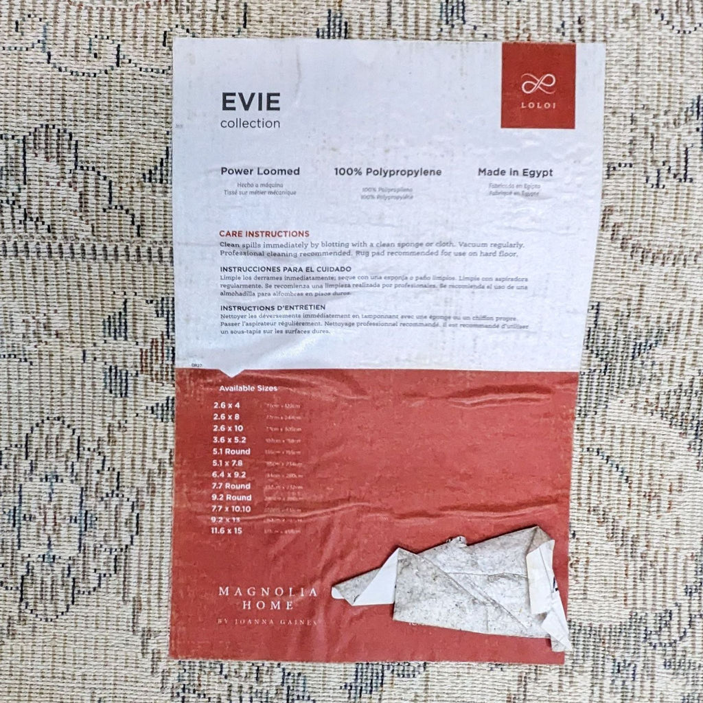 Label on the Evie rug, showing care instructions and available sizes from Magnolia Home.