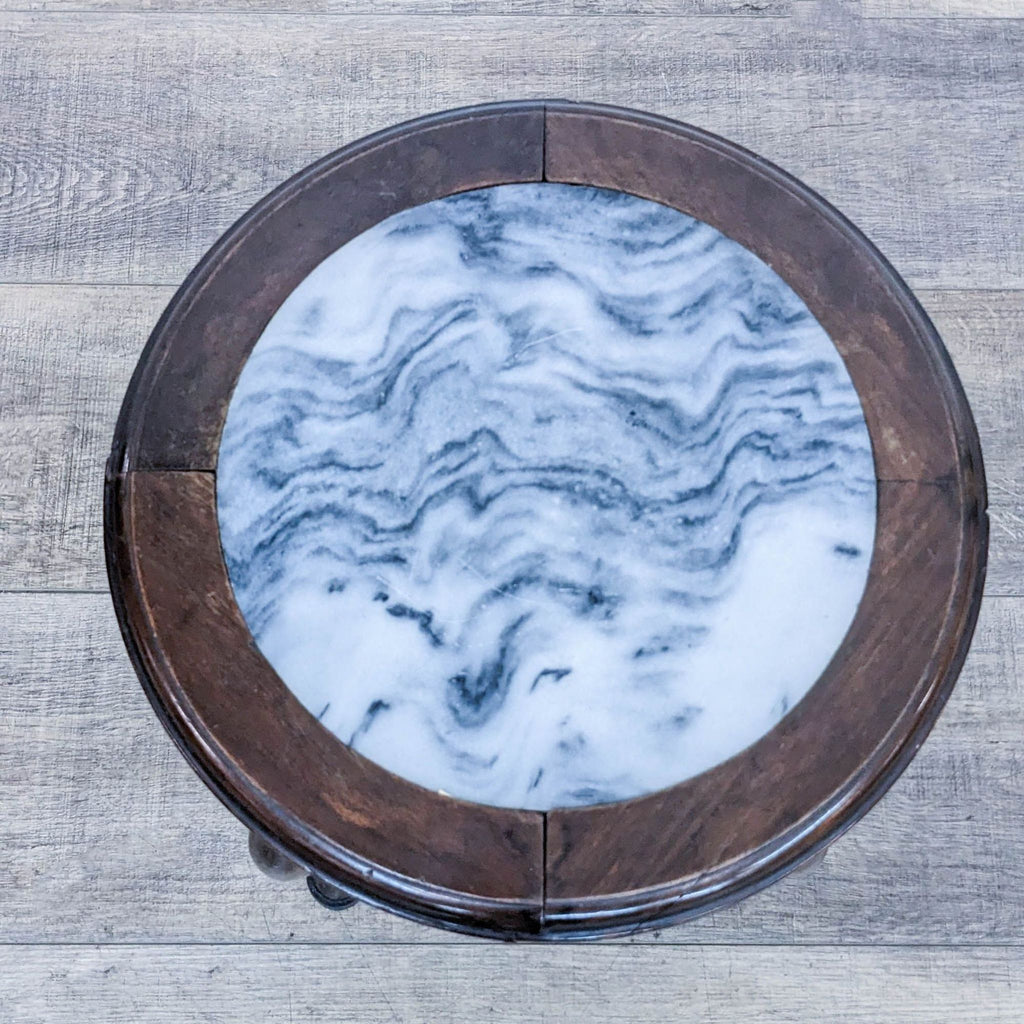 3. Top view of Reperch side table, highlighting the round, swirling-pattern marble top and wood frame.