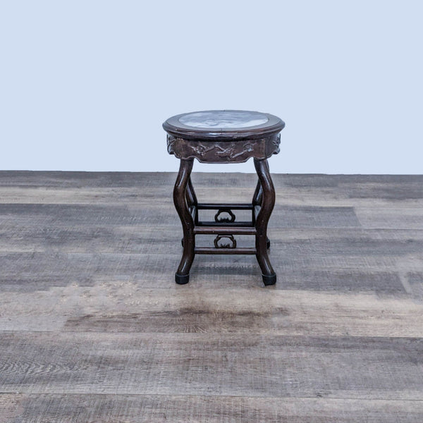 1. Reperch side table with curved wooden legs and a round marble top, displayed on a wooden floor.