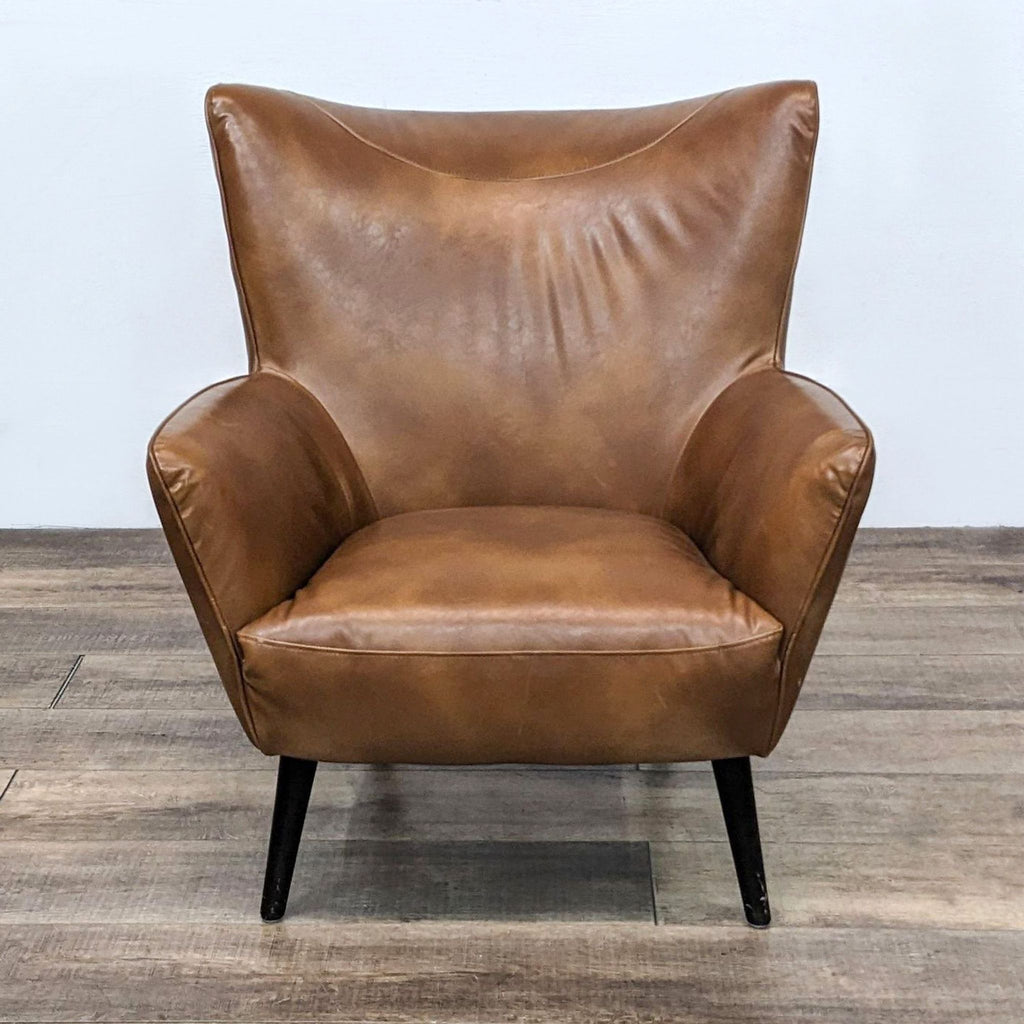 Front view of a brown faux leather side chair with clean lines and wooden legs.