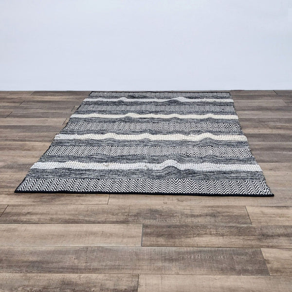 Boho style ivory and black rug with varied textures and patterns.
