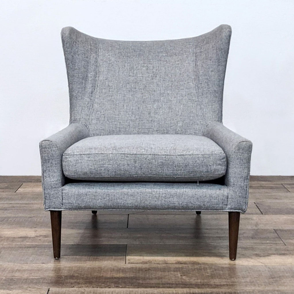 Front view of the Marlow chair with sleek lines and tapered wooden legs.