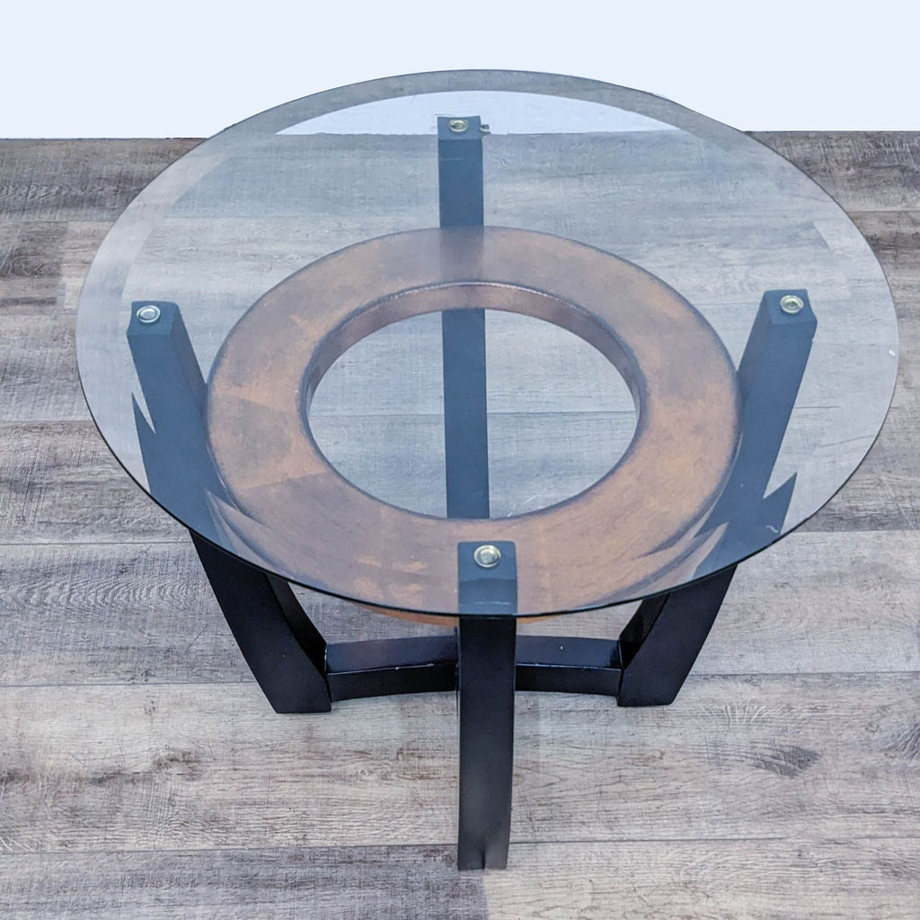 Reperch end table showcasing a glass surface, wood accent, and dark crossing legs.