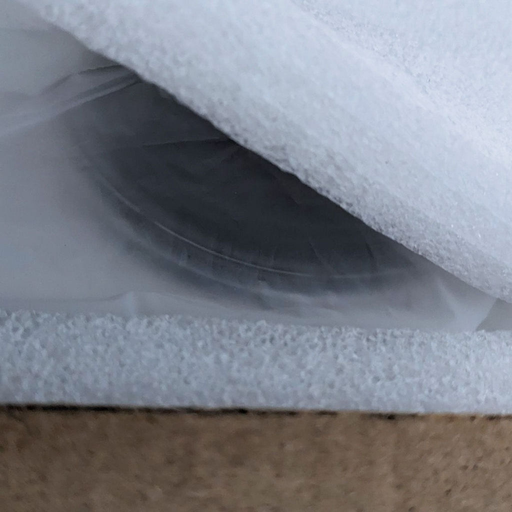 Detailed view of the Vankyo projector partially wrapped in protective foam.
