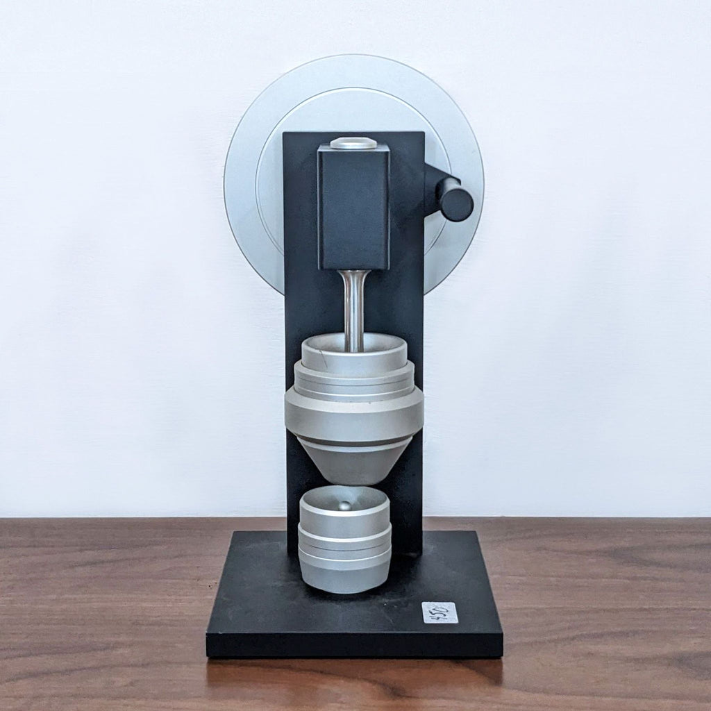 1. Sleek black and silver mechanical device with cylindrical components and a sturdy base.