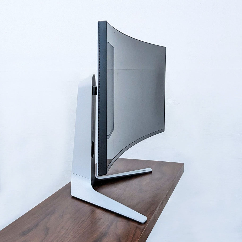 Side view of Alienware curved monitor showing its slim design and stand.