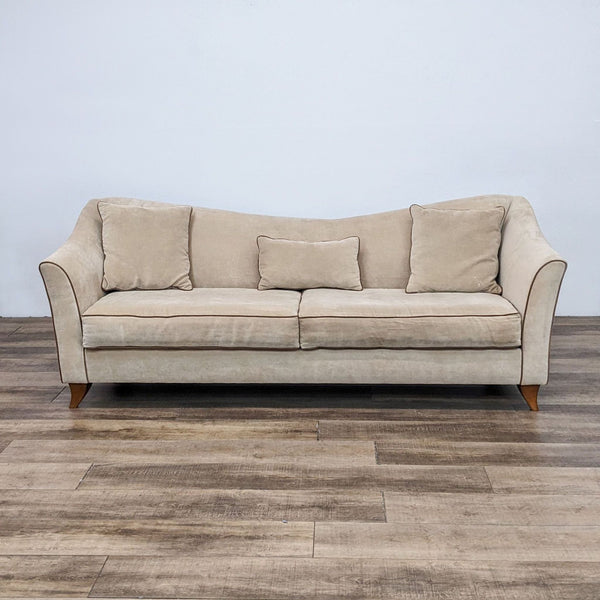 Front view of a beige 3-seat fabric sofa with wood feet and contrasting piping.
