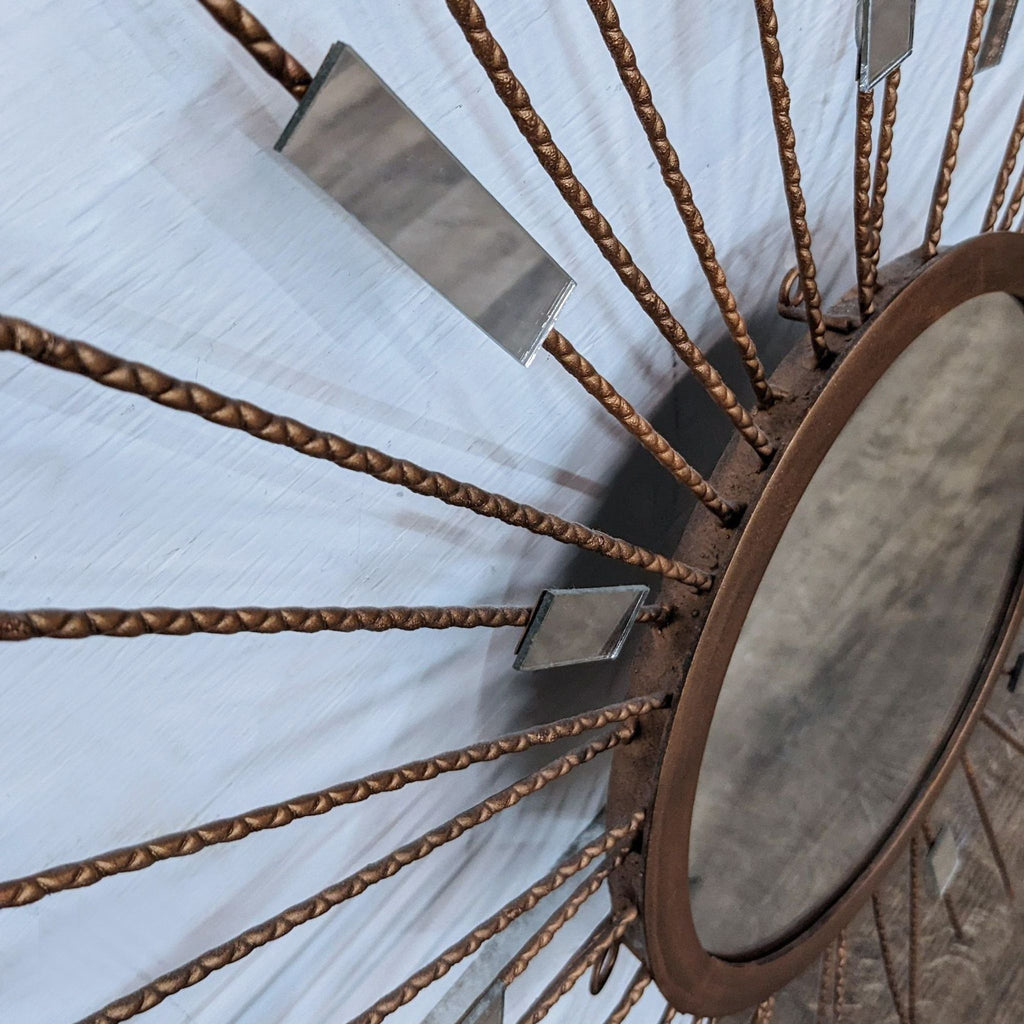 Side view of a starburst mirror showing detailed metal strands and mirrored pieces.