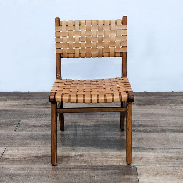 Front view of a solid teak dining chair with woven leather straps by Teak Me Home.