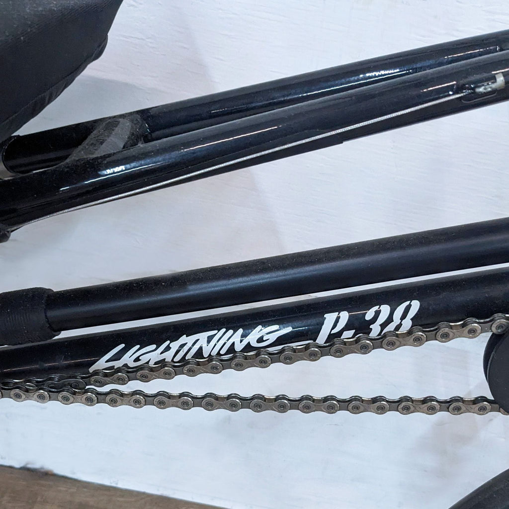 Close-up of Lightning P-38 branding on a black bike frame.