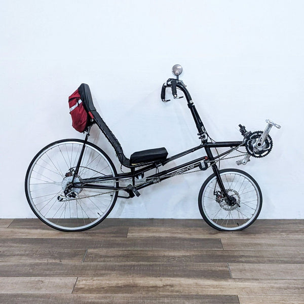 Recumbent bike from Lightning with a sleek design and red saddlebag.