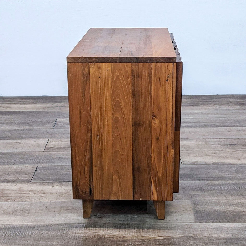 Side view of a wooden bar cabinet highlighting its natural teak grain and sturdy construction.
