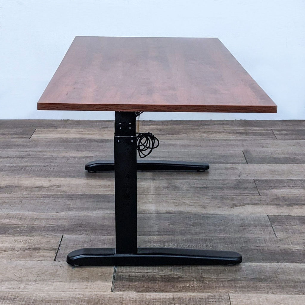 Five-foot desk by Reperch featuring a wooden top and motorized adjustable black steel frame.