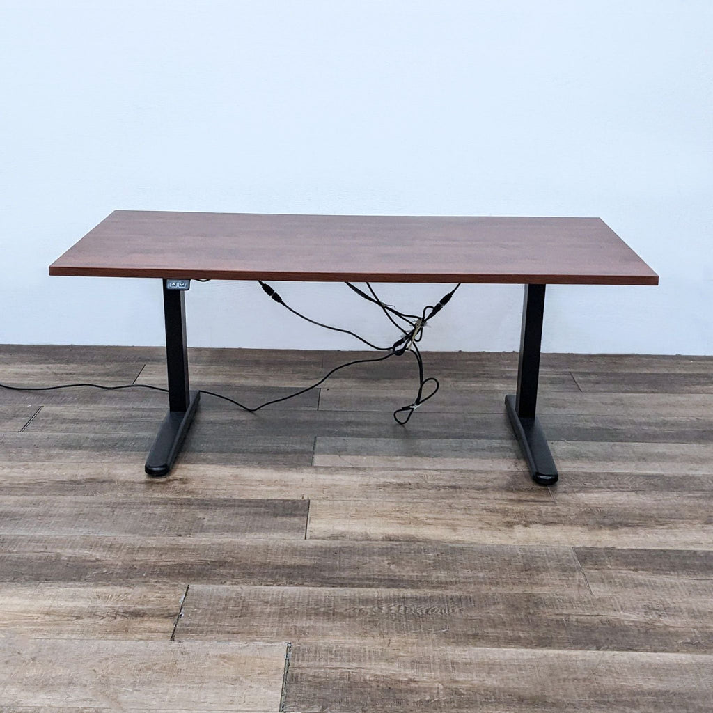 Reperch desk with motorized height adjustment, wooden surface, and black steel frame, five-foot length.