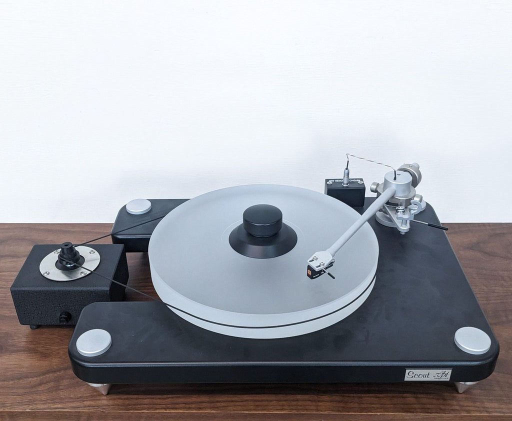Detailed view of the VPI Scout turntable with focus on its tonearm and platter mechanism.  
