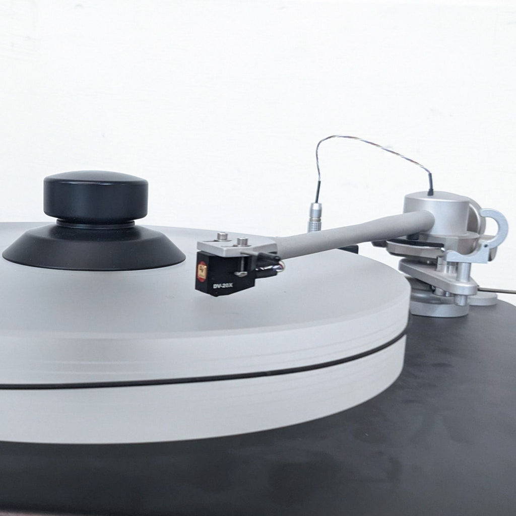 Close-up of the VPI Scout turntable's tonearm and cartridge on the sleek platter.  