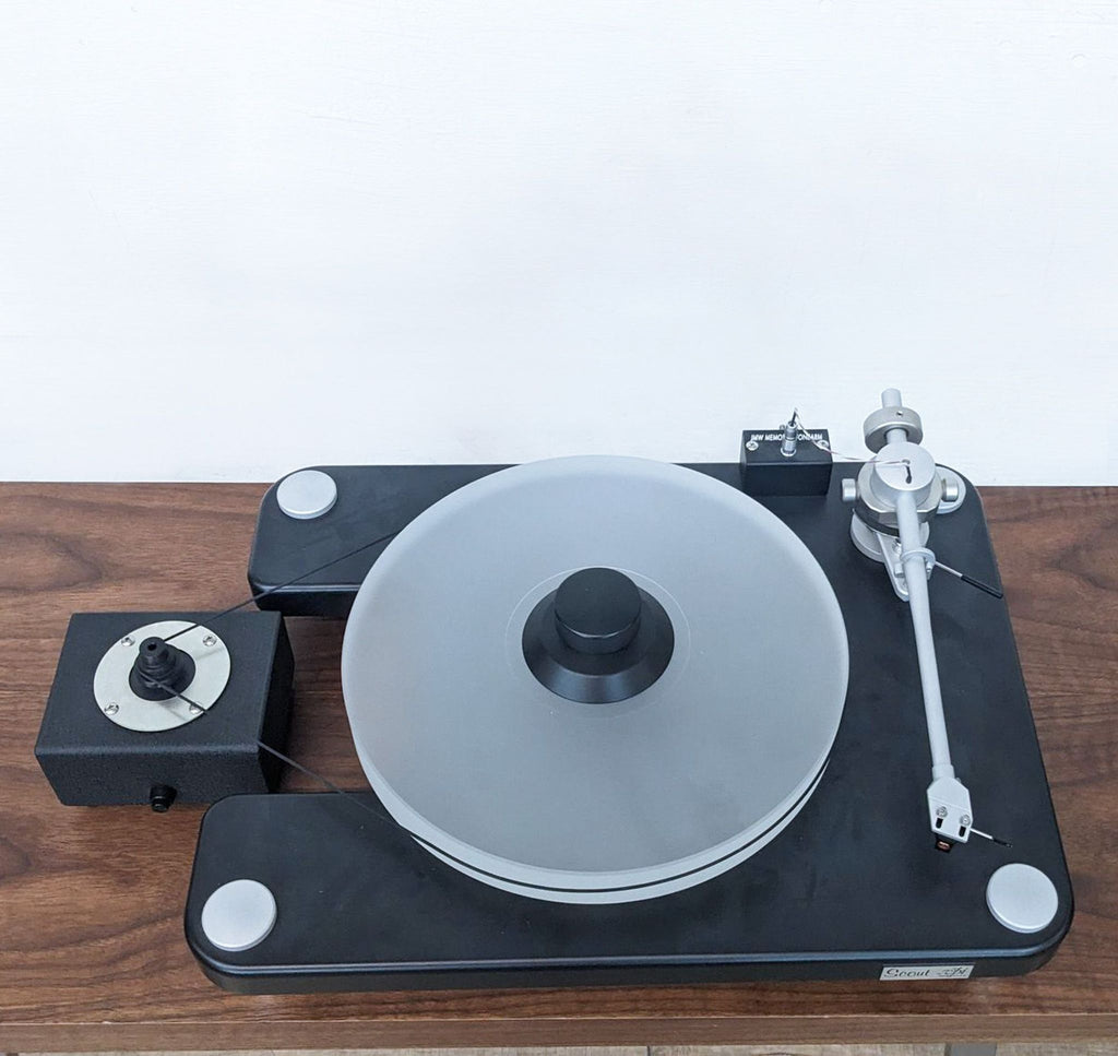 VPI Scout turntable on a wooden surface, showcasing the platter and tonearm setup.  