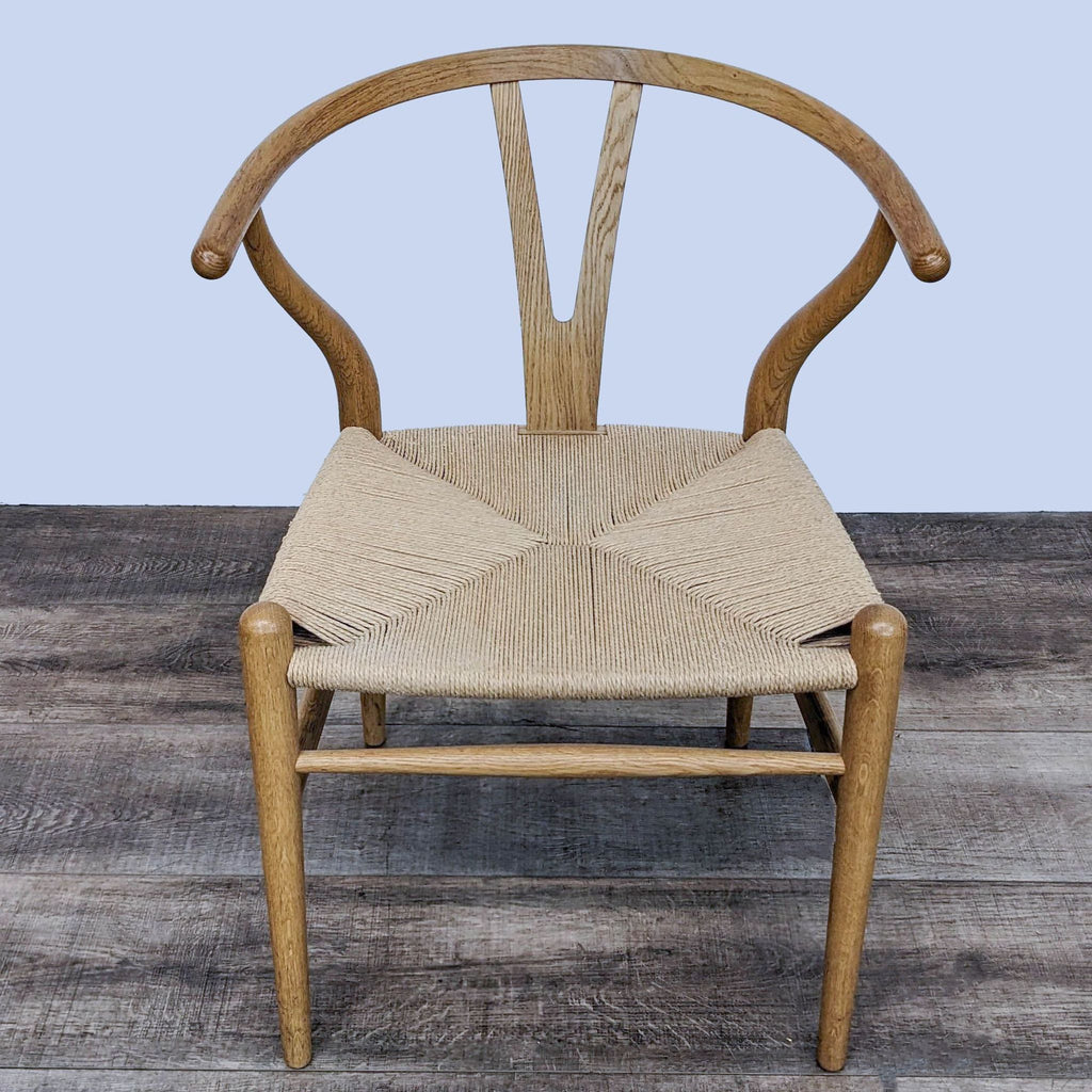 Wegner Wishbone Chair with natural woven seat, showcasing elegant curves and solid wood frame.