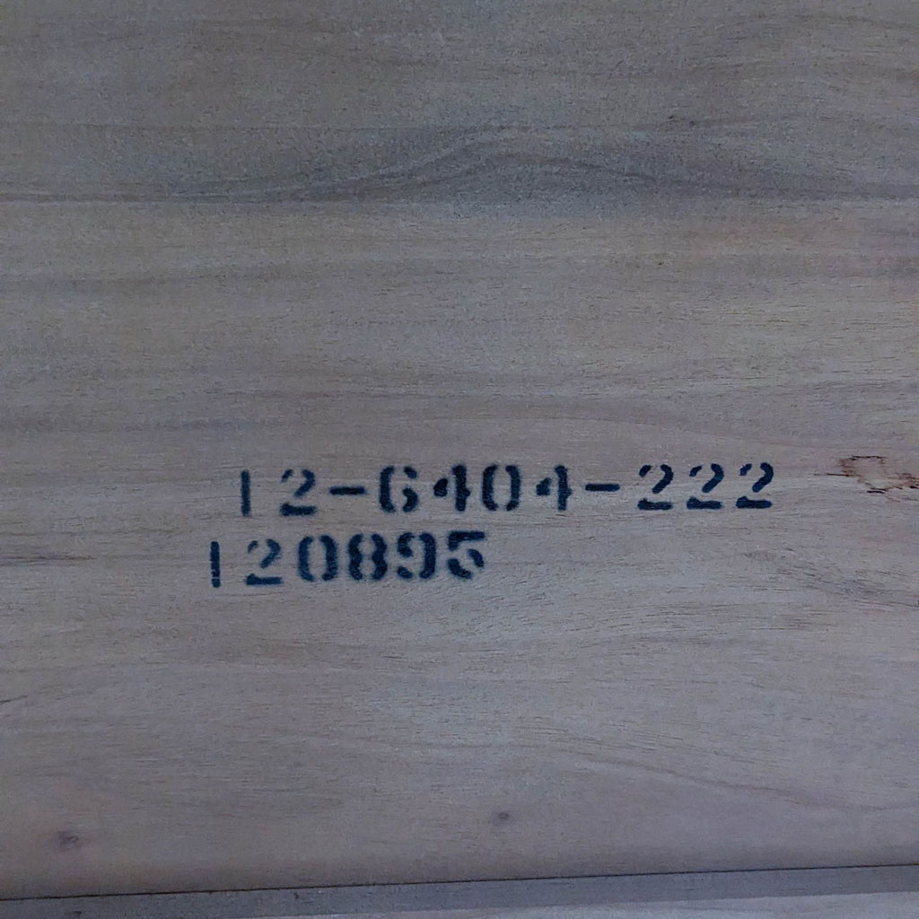 Close-up of code on the underside of an Ethan Allen dining table.