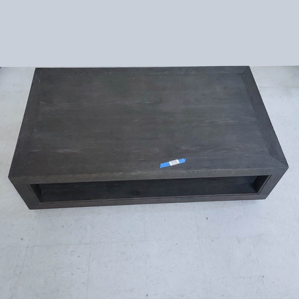 Top view of a minimalist dark wood coffee table by Restoration Hardware, with visible wood grain.
