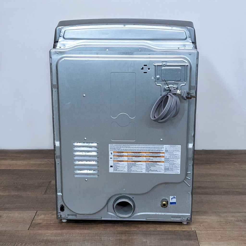 Back view of a Whirlpool washer/dryer displaying the metal panel, vent, power cord, and utility connections.