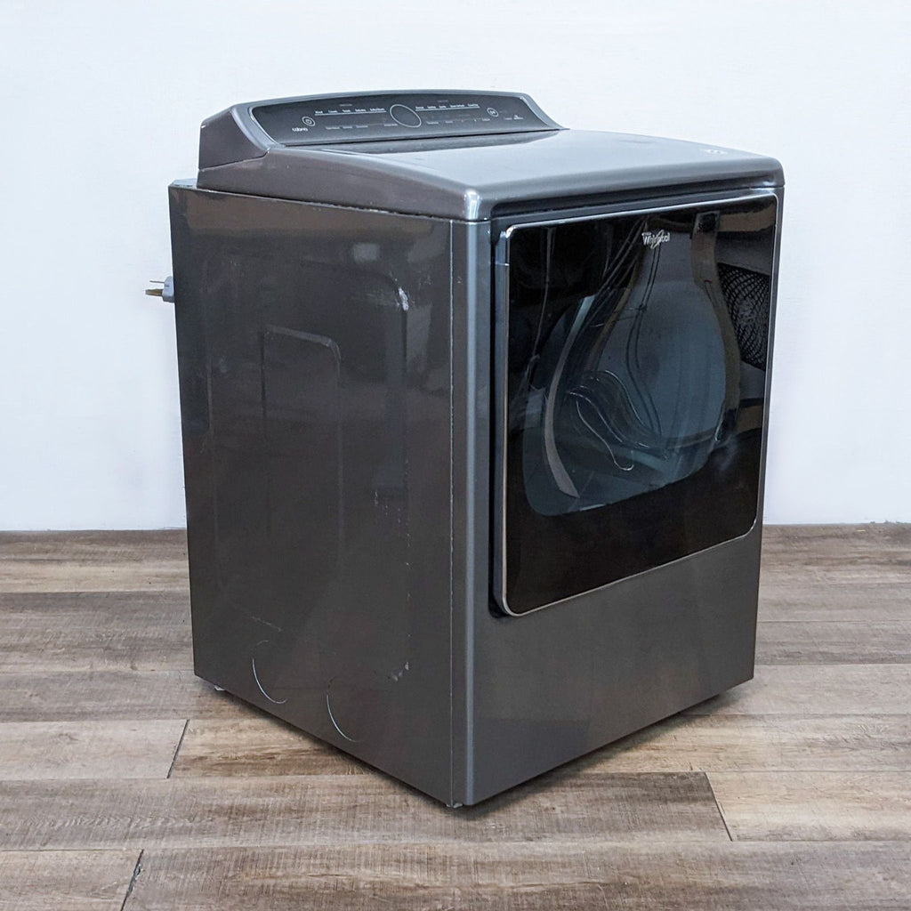 Angled side view of a Whirlpool washer/dryer appliance, showing the depth and sleek, modern build.