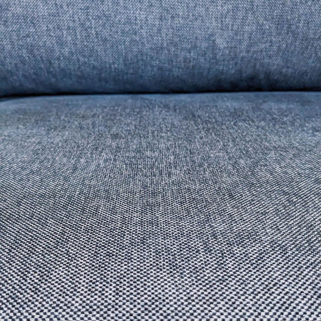 Close-up of blue fabric texture on a three-seat Ikea sofa, highlighting its detailed weave.