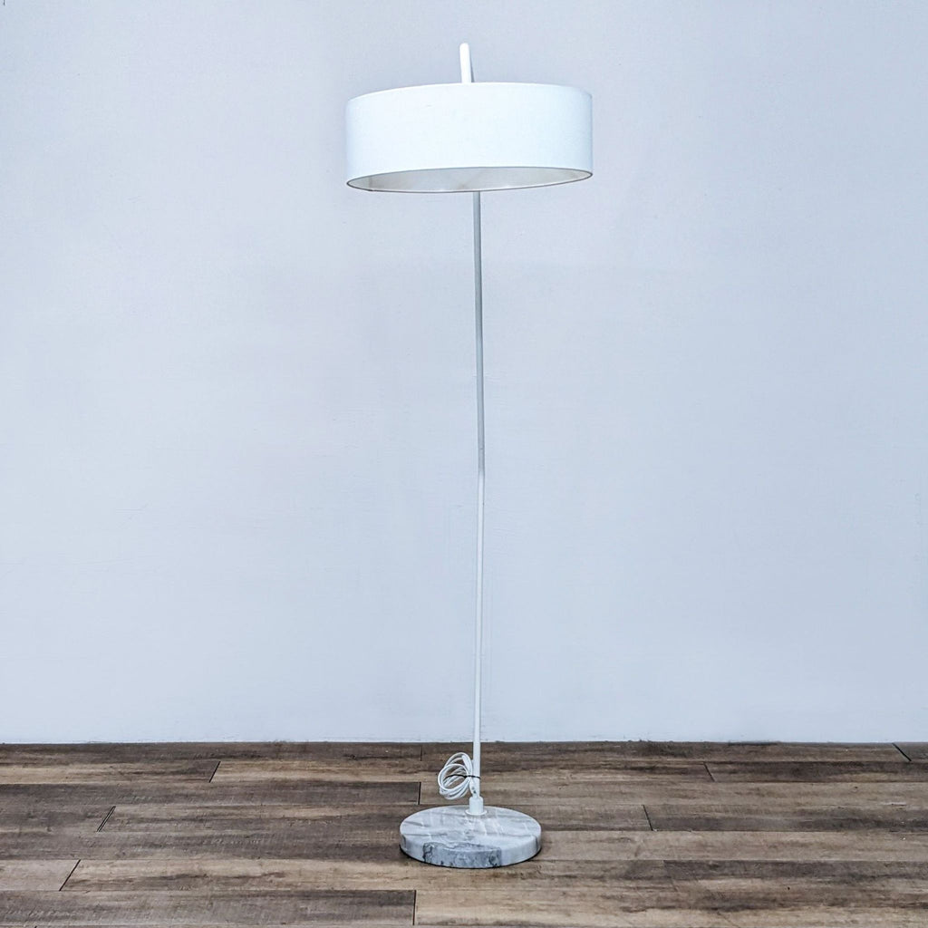 Straight-standing white floor lamp with a circular shade and marble base.  