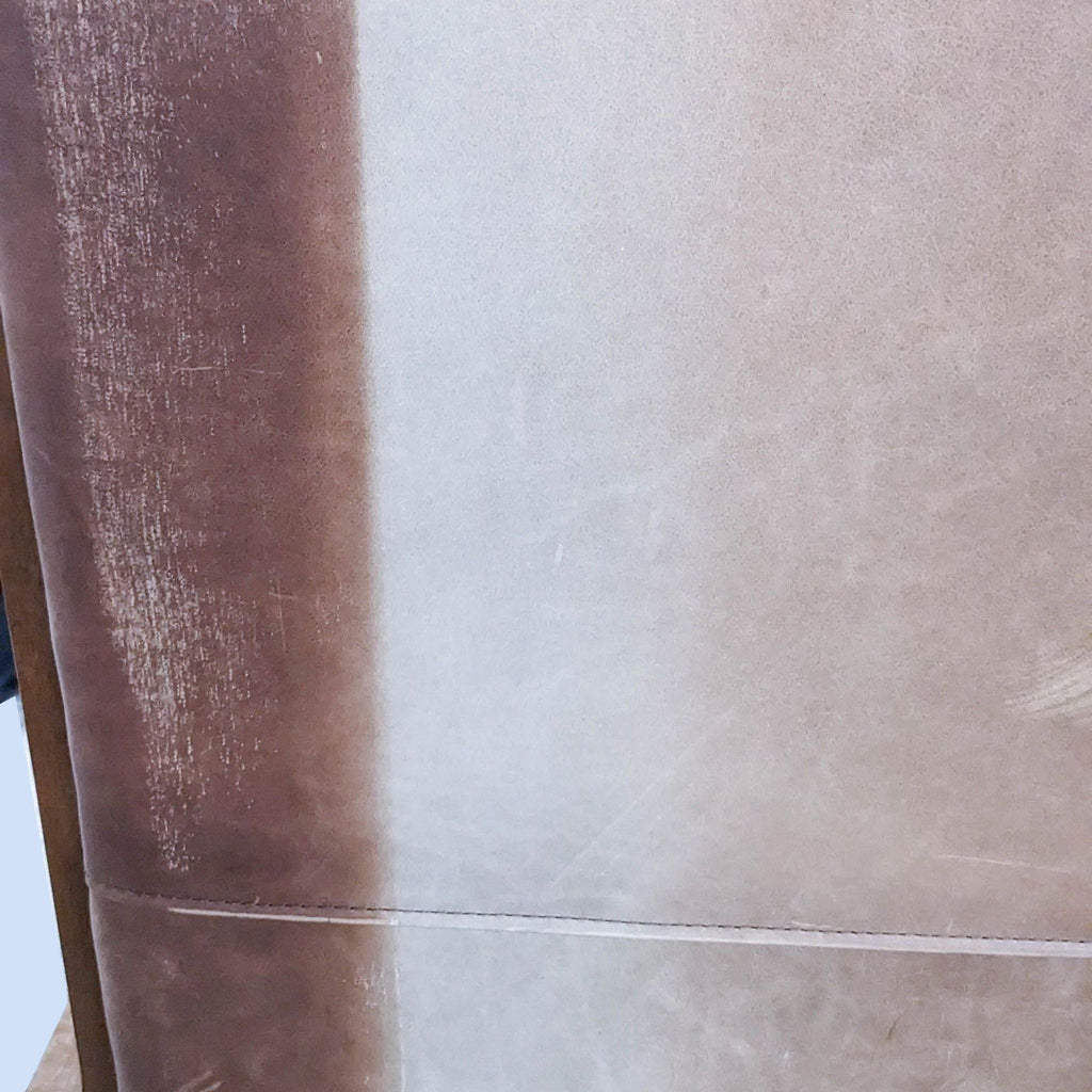 Close-up of worn brown leather texture highlighting the material's detail.