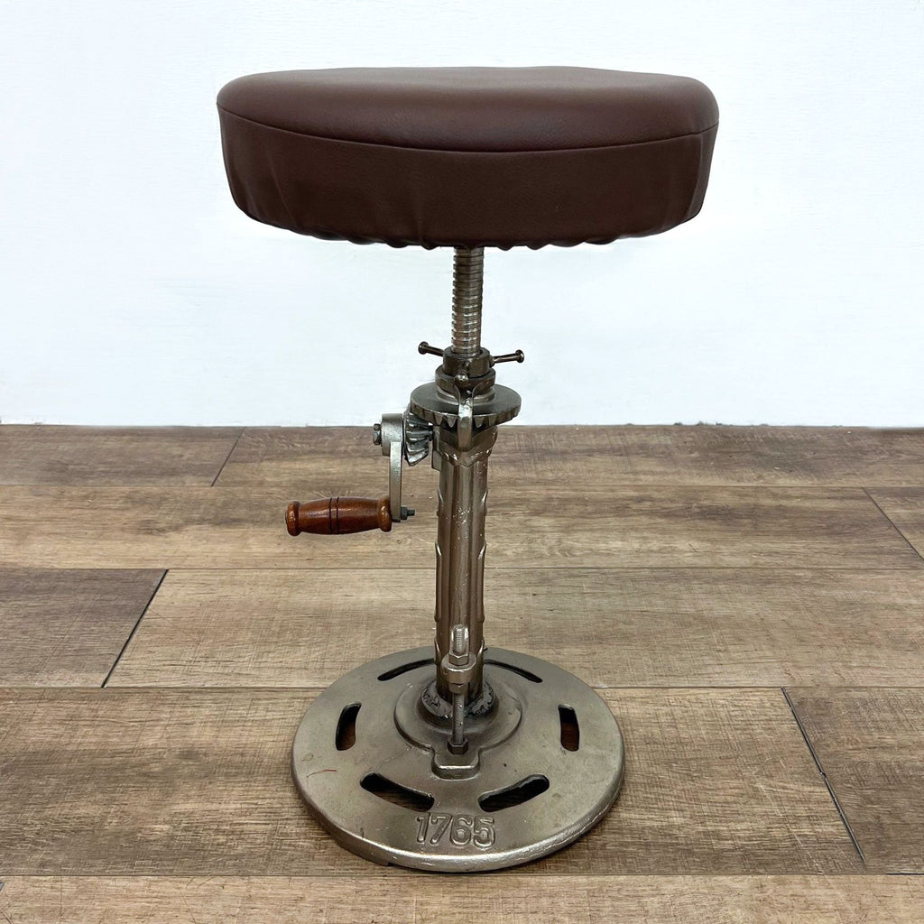 2. Adjustable metal-framed stool with brown leather top, markings 1765 and AJ.