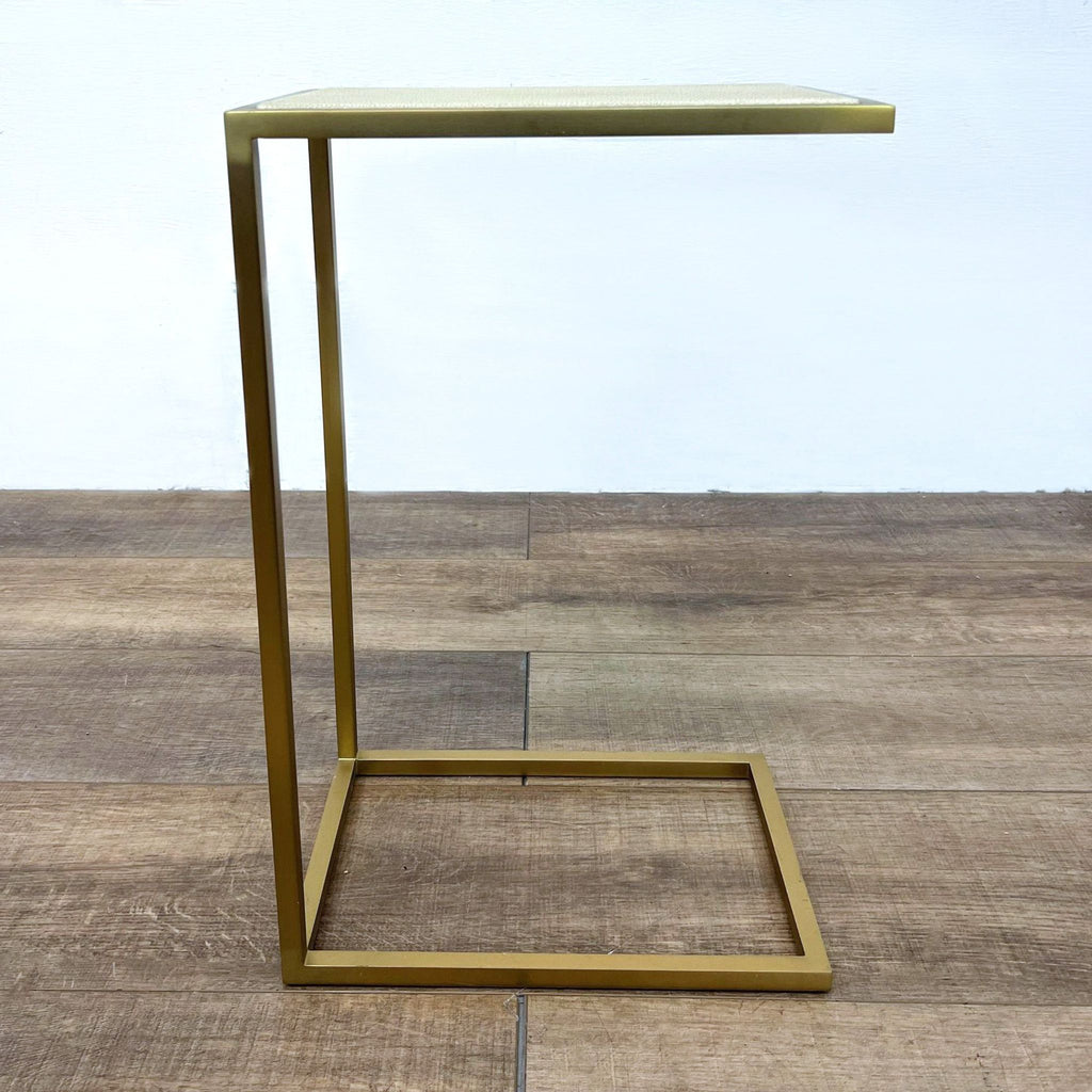 Modern end table featuring shagreen-embossed leather and a brass-finished steel frame.