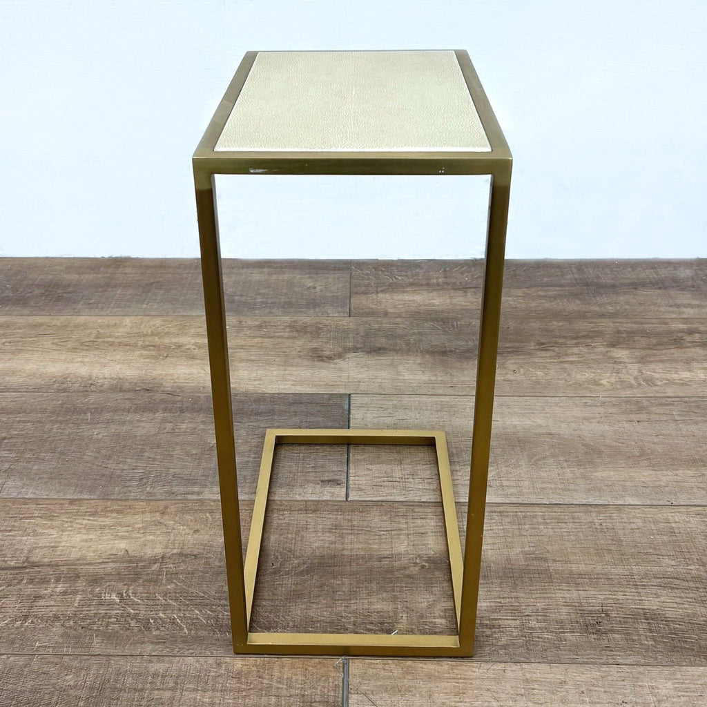 End table with shagreen-style leather surface and brass steel base. From Restoration Hardware.
