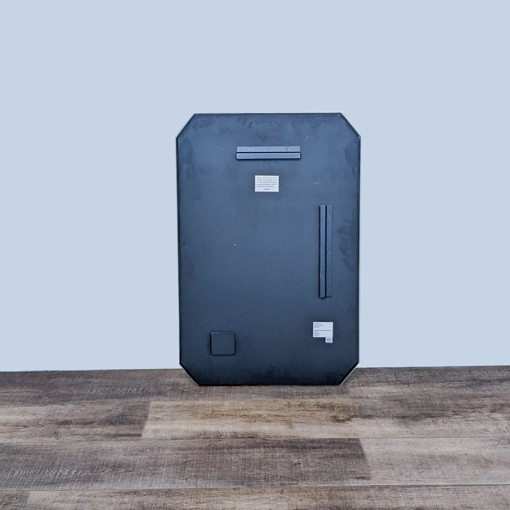 Reflective Remolino mirror displaying a floor reflection, Crate & Barrel design.