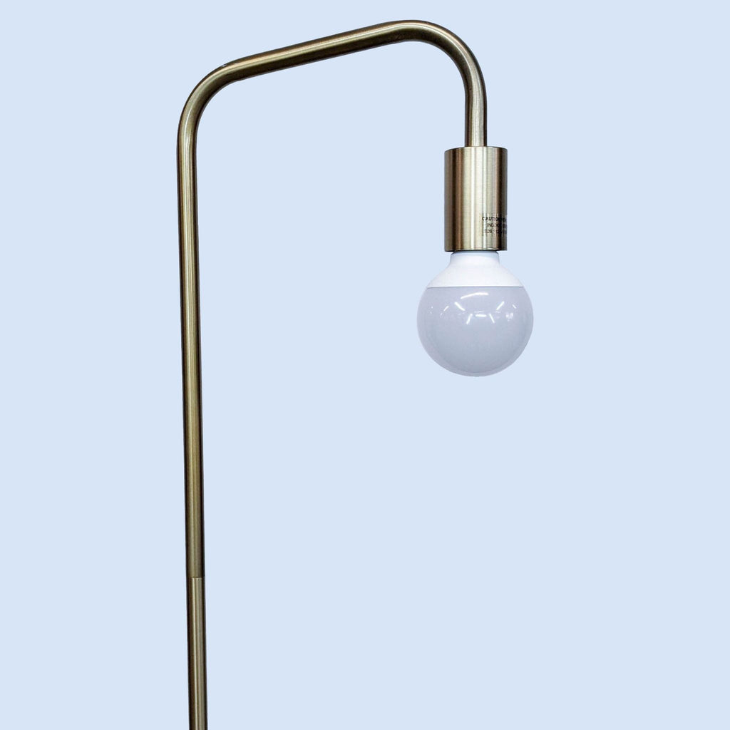 2. Close-up of the Reperch floor lamp's curved metallic top and exposed round bulb, minimalist lighting design.