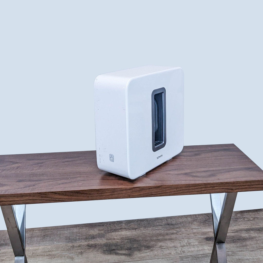 Side view showcasing the slim design of a white Sonos subwoofer.  