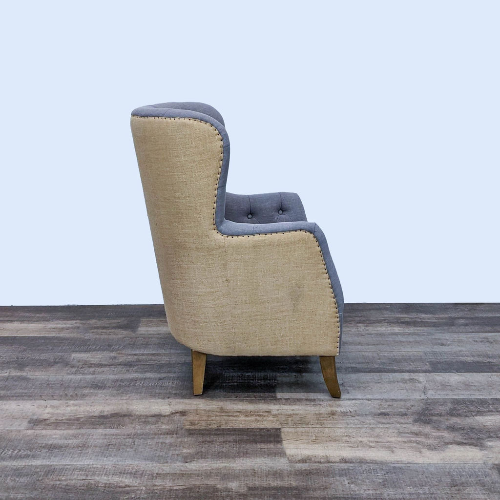 Side view of Reperch lounge chair showing contrasting upholstery and nailhead trim detailing.