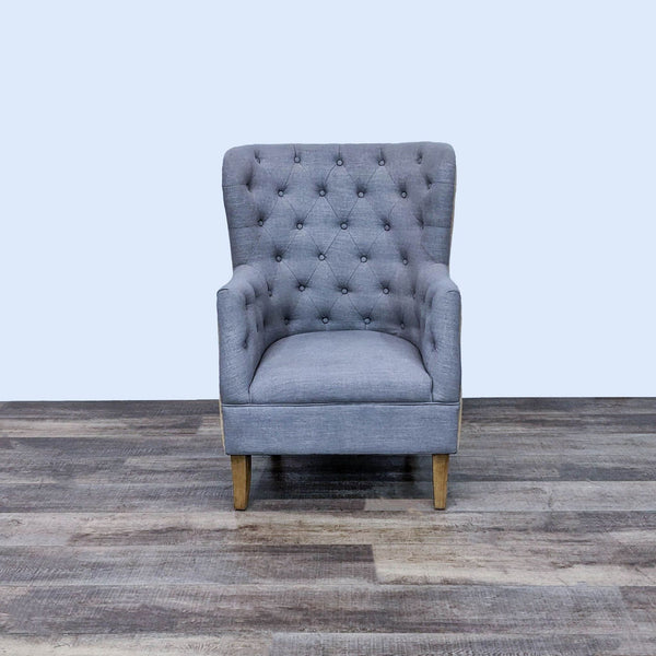 Front view of a contemporary wingback chair by Reperch, with tufted woven fabric upholstery.