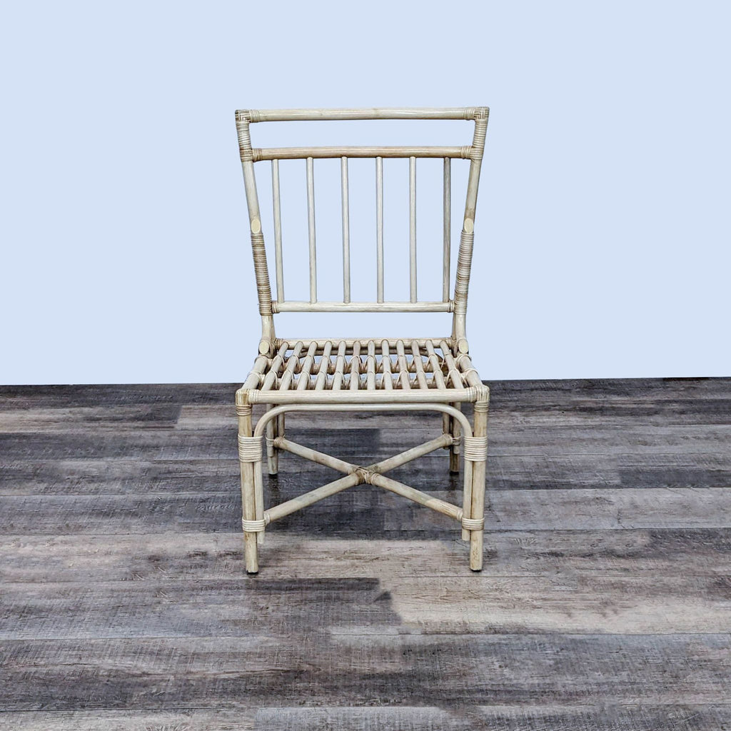 Pottery Barn side chair with sleek rattan design, perfect for dining areas.