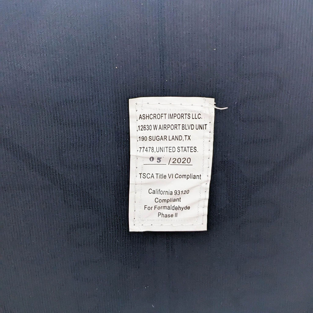 Label showing compliance and manufacturing information from Ashcroft Imports LLC.