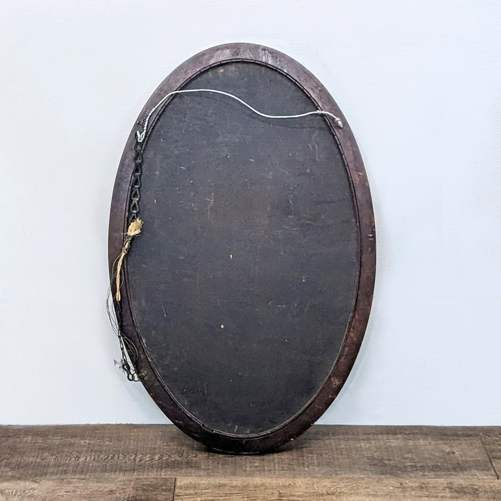 Back view of Reperch oval mirror, showing hanging wire and wooden frame.