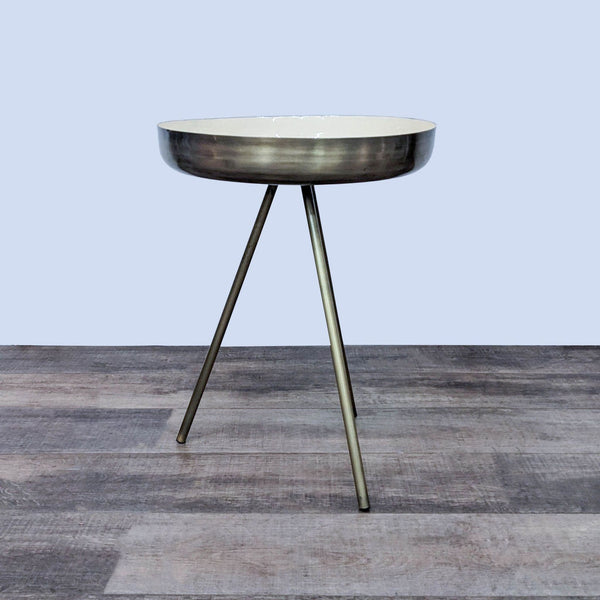 Enamel-topped side table with antique brass steel base on wooden floor.