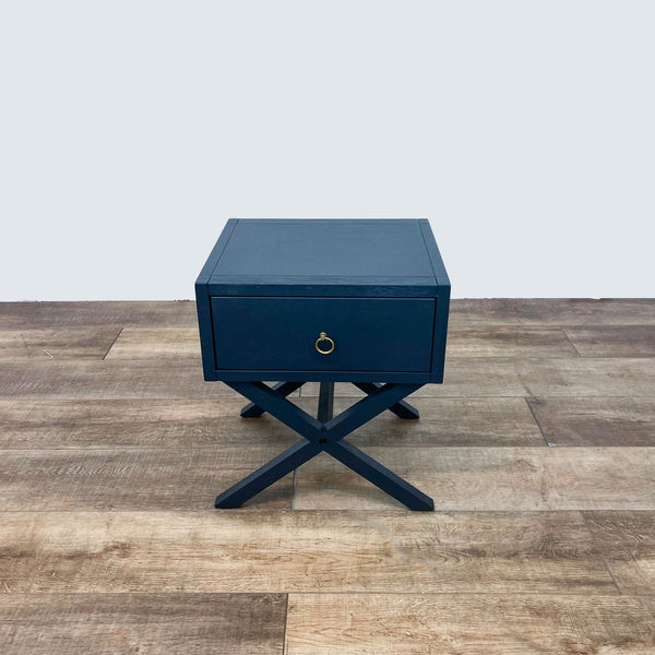 Reperch End Table in blue with cross legs and a single drawer.  