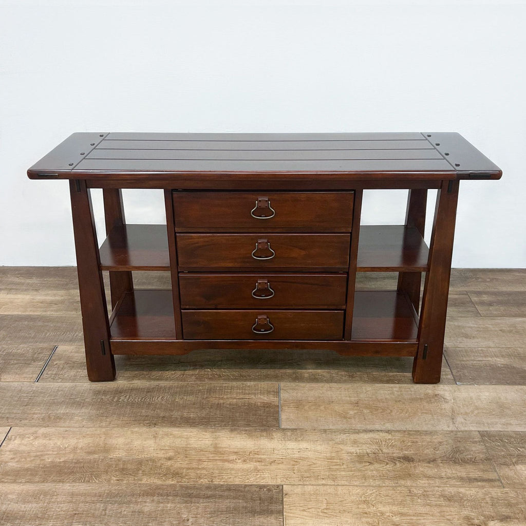 Wooden console table with planked top, drawers, and side shelves.  
