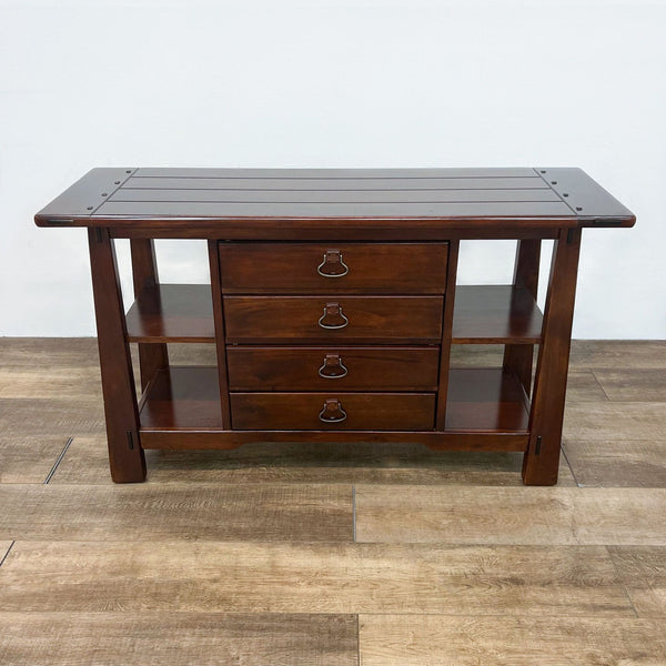 Wooden console table with planked top, drawers, and side shelves.  