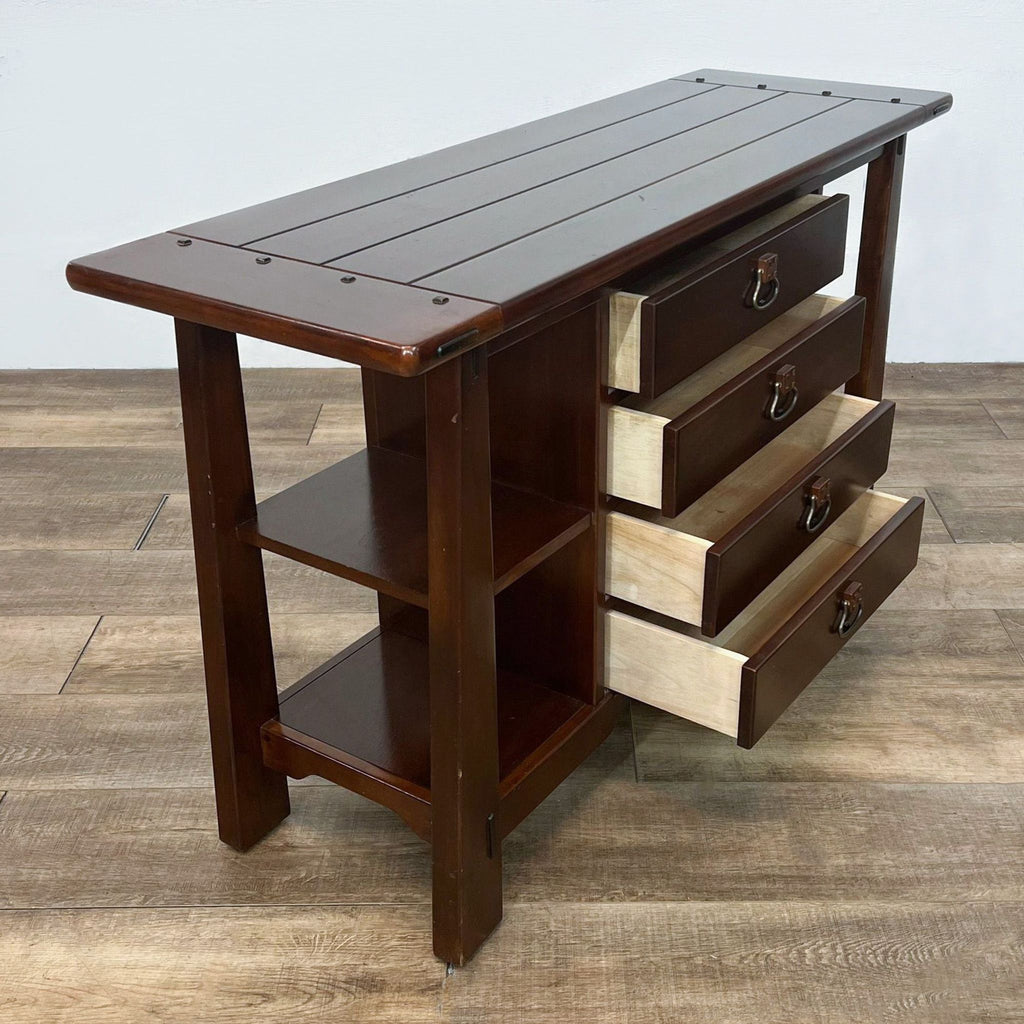 Side view of console table showing open drawers and shelving.  